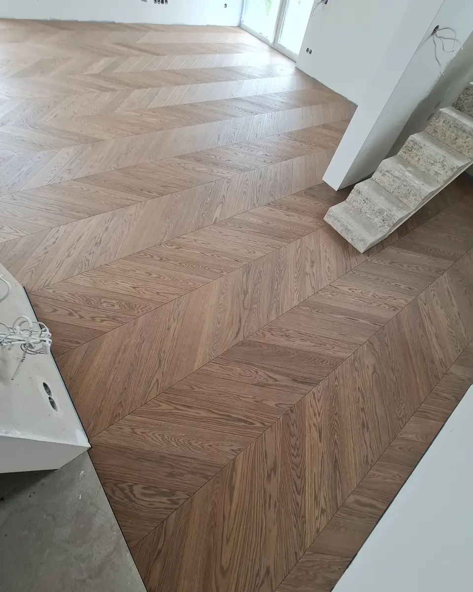 Oak chevron meeting the edge of a staircase