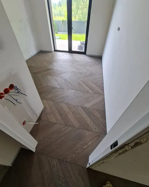 Grey smoked oak chevron beside a window