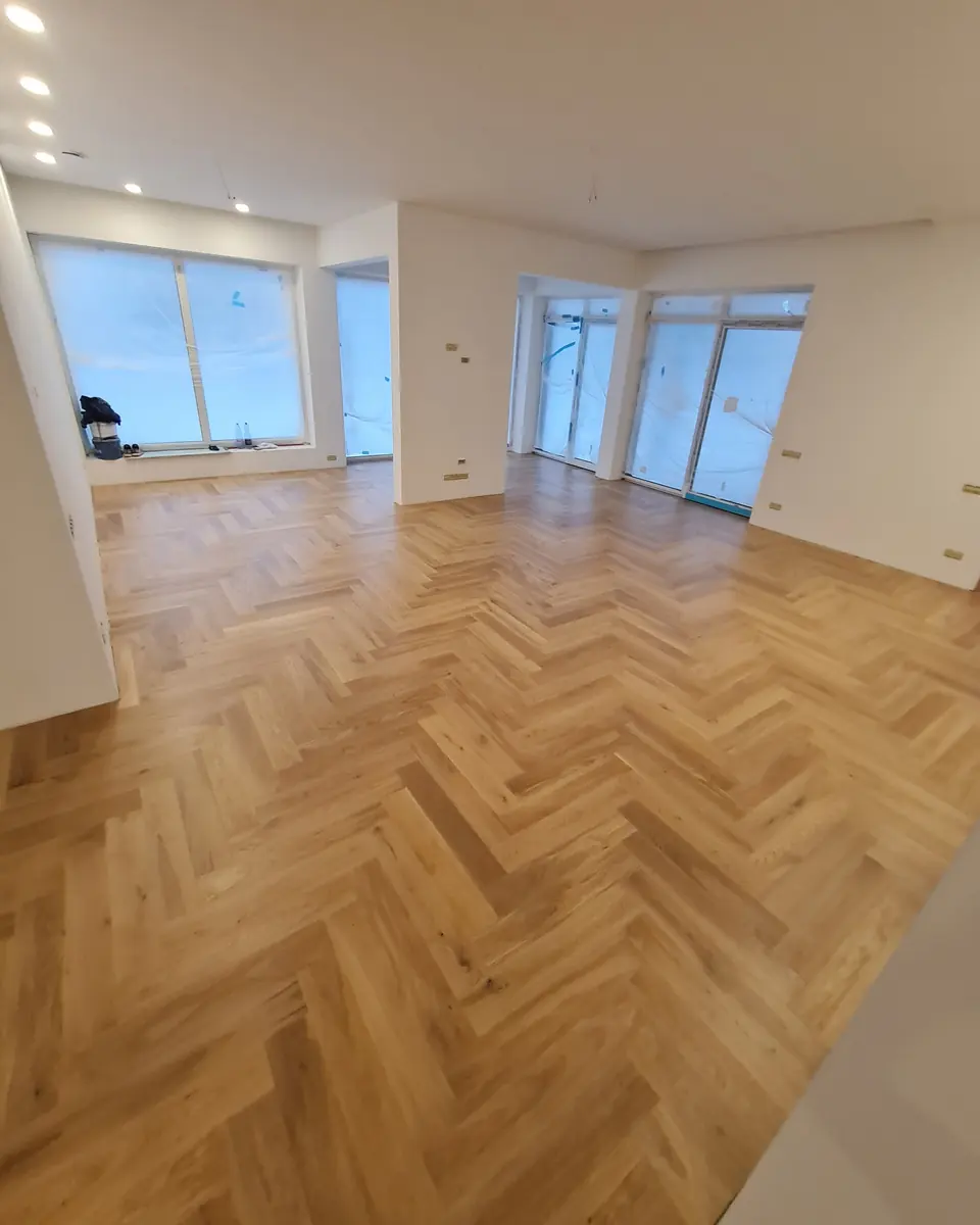 Oak classic herringbone in a bright room with panoramic windows